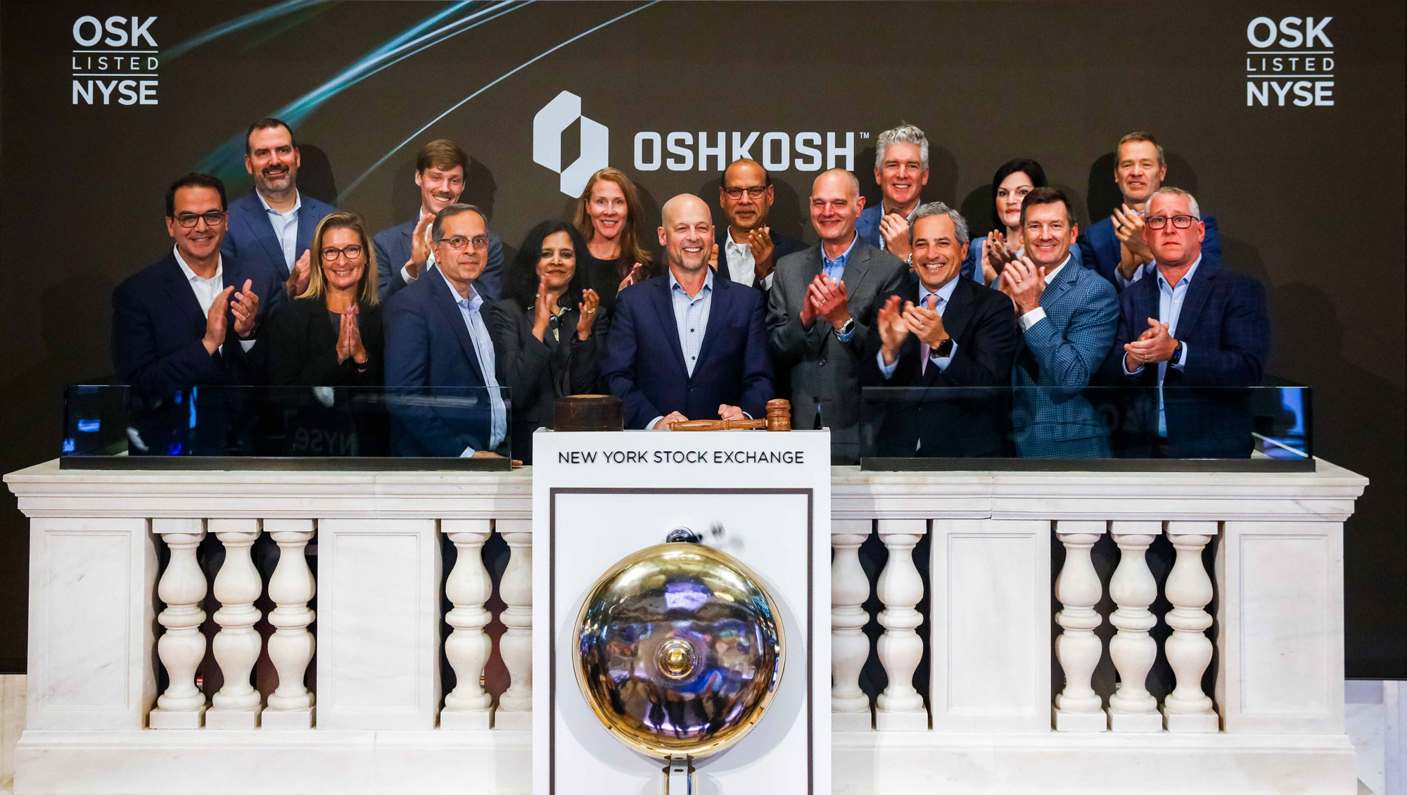 Oshkosh leaders on the NYSE closing bell podium