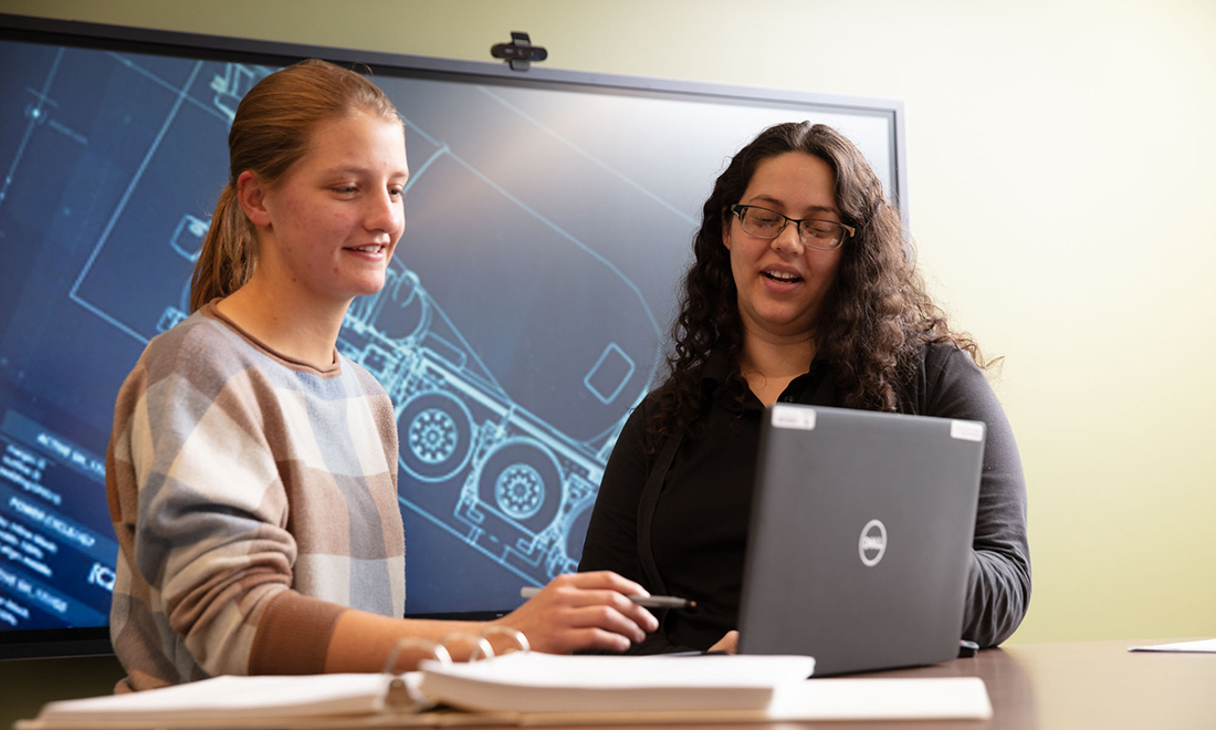 Two engineers working on laptop
