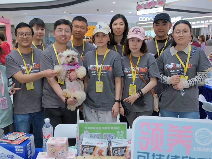 Team members with dogs at adoption event