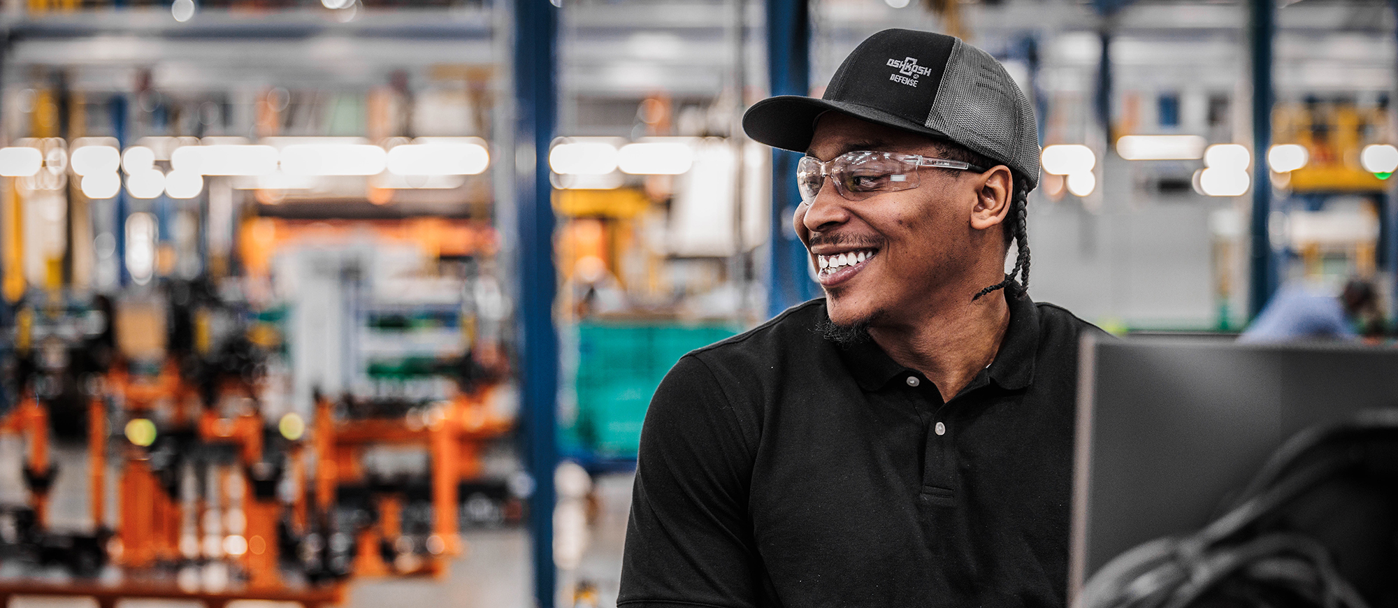 Team member in warehouse smiling