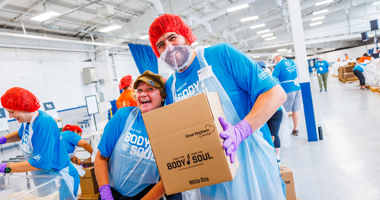  Two employees at Oshkosh Feed the Body, Feed the Soul event 2025