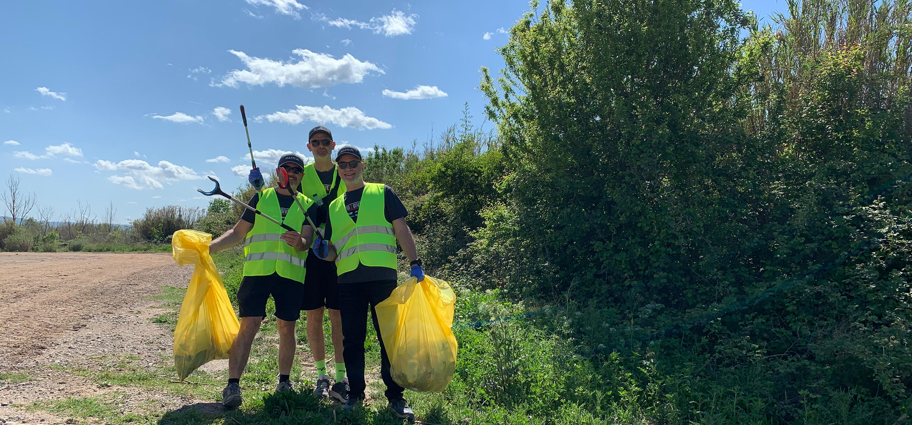 Team members picking up trash in Spain